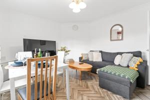 a living room with a couch and a table at Cozy 3 Bedroom House For Short and Long Stay in Lower Gornal