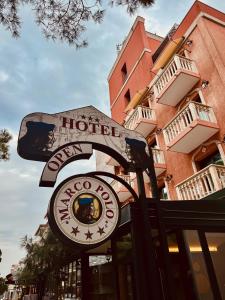 a sign for a hotel in front of a building at Hotel Marco Polo in Lido di Jesolo