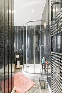 a bathroom with a shower and a bath tub at Cozy 3 Bedroom House For Short and Long Stay in Lower Gornal