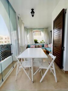 a white table and two chairs in a room at Serene & Joyful Retreat - Breathtaking view in Cabo Negro