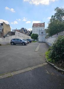 a car parked in a parking lot next to a building at Le National 2 Appartement centre ville avec Parking privé in Tourcoing