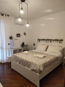 a bedroom with a large bed with two white pillows at Leonardo Rome Holidays in Fiumicino