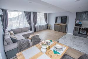 a living room with a couch and a table at Balkan Tower Deluxe Ultra in Gabrovo