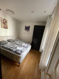 a bedroom with a bed in the corner of a room at OSLO S, City Center Apartments in Oslo