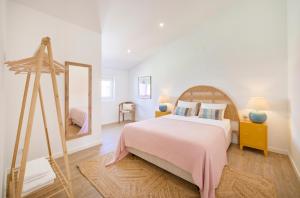 a bedroom with a large bed and a mirror at Ocean & Sun Terrace w AC, by TimeCooler in Costa da Caparica