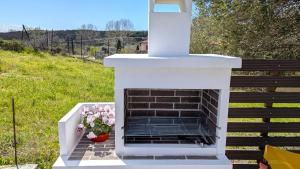 a white fireplace with a vase of flowers at Vanna's Holiday House in Ierissos +27 photos