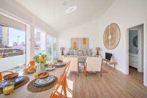 a kitchen and living room with a table and chairs at Ocean & Sun Terrace w AC, by TimeCooler in Costa da Caparica +51 photos