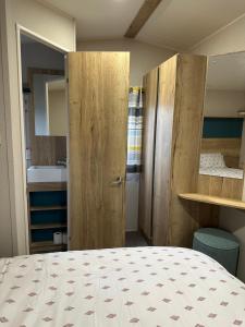 a bedroom with a bed and a bathroom with a sink at Silver Dunes in Lossiemouth +15 photos