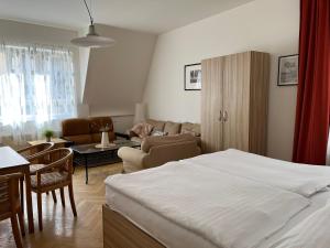 a bedroom with a bed and a living room at Residence u Vejvodů in Prague