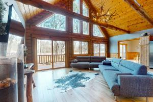 a living room with a blue couch and some windows at Golfview Lodge in New Rome
