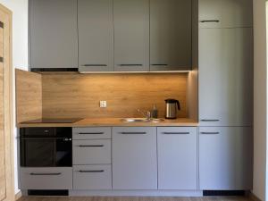 a kitchen with white cabinets and a sink at Słoneczne tarasy in Życiny +82 photos