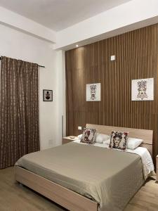 a bedroom with a large bed with two pillows at B&B Melissa in Noto
