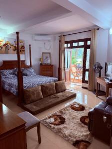 a living room with a bed and a couch at Resident View Homestay in Kandy