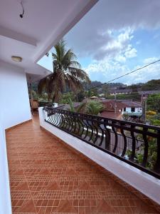 a balcony with a view of a palm tree at Resident View Homestay in Kandy +51 photos