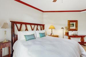 a bedroom with a large white bed with blue pillows at Snowcap Sanctuary in Ketchum