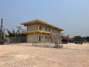 a house with a fence in front of it at VNR apartments in Belmopan