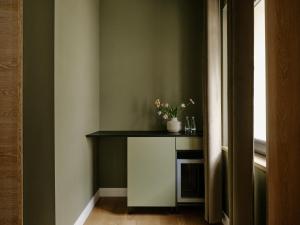 a room with a table with a plant on it at Art Apartments in Berlin