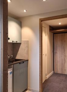 a kitchen with a sink and a counter top at Studio Ariondaz in Courchevel