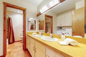 a bathroom with two sinks and a large mirror at 3622 Winterberry in Wilson +39 photos