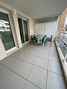 a balcony with two chairs and a table at Frejus Plage in Fréjus