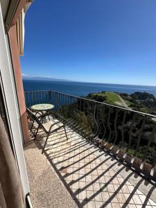 a balcony with a table and a view of the ocean at B&B Martina in Taormina