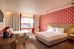Postel nebo postele na pokoji v ubytování Hotel The Augustin