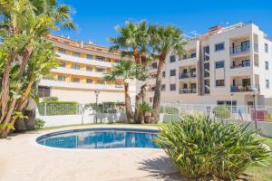 a hotel with a swimming pool in front of a building at Apartment El Sol in Moraira