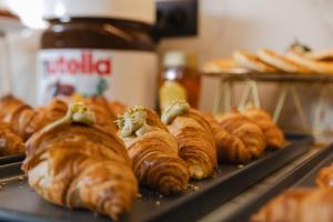 a bunch of croissants on a tray in a bakery at Hotel Marco Polo in Lido di Jesolo
