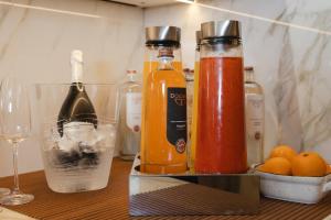 a table with two bottles of alcohol and some oranges at Hotel Marco Polo in Lido di Jesolo