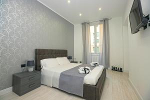 a bedroom with a large bed and a television at Guest House Genova Holiday in Genova