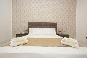 a bedroom with a large white bed with two night stands at Guest House Genova Holiday in Genova