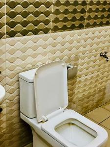 a bathroom with a white toilet in a room at La suite grise in Dakar
