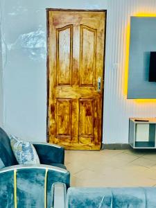 a wooden door in a room with a couch at La suite grise in Dakar +21 photos