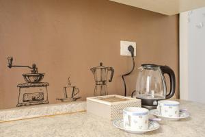 Coffee and tea making facilities at Tirelli Apartment Roma