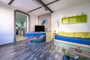 a living room with a couch and a tv at Gio's Gio's House in Monserrato