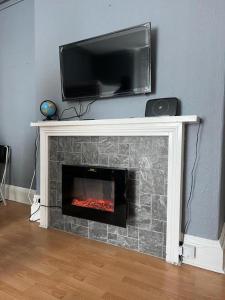 einen Kamin mit einem TV darüber. in der Unterkunft rhyl apartments in Rhyl