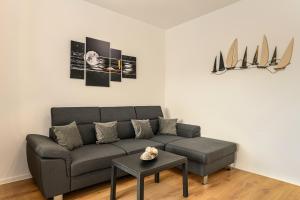 a living room with a couch and a table at Luxury Landing Apartments Complex Qualis Brasov in Braşov