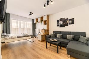 a living room with a couch and a table at Luxury Landing Apartments Complex Qualis Brasov in Braşov +165 photos