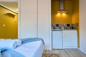 En eller flere senge i et værelse på Studio tout confort