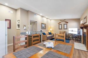 a kitchen and living room with a table and a refrigerator at Evergreen Ridge 27 in Kimberling City