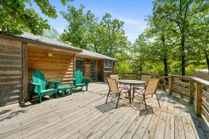 a deck with a table and chairs on a cabin at Evergreen Ridge 27 in Kimberling City