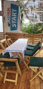 a bed and chairs on a wooden deck at Moivaro eco hostel in Arusha