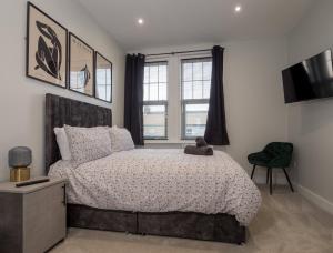 a bedroom with a bed with a teddy bear on it at Dwell Living North Bridge Apartments in Sunderland