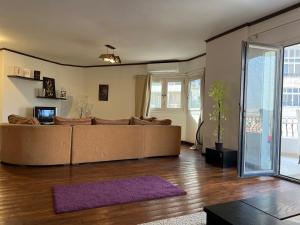 a living room with a large couch and a purple rug at St Regis Apartment Degla Maadi in Cairo