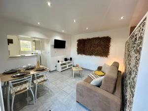 a living room with a couch and a table at La Pause Nature in Incheville