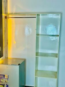 a refrigerator with its door open with empty shelves at Orange Room in Dakar +42 photos