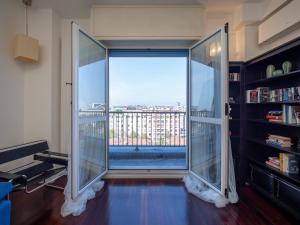 a room with a large glass door with a view at Residence Vigliani in Milan
