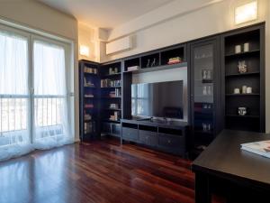 a living room with a television and bookshelves at Residence Vigliani in Milan