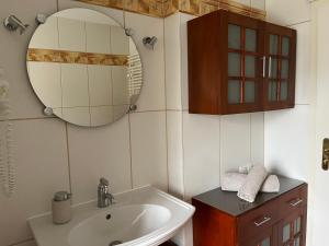 a bathroom with a sink and a mirror at Gemütliche strandnahe Ferienwohnung in Bansin