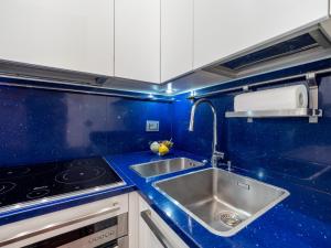 a blue kitchen with a sink and a stove at Residence Vigliani in Milan +69 photos